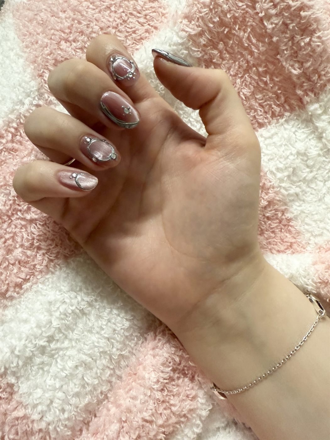 Short natural nails with soft chrome and small heart details